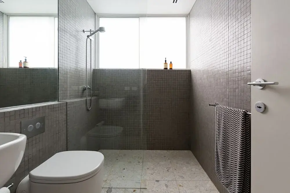 Frameless glass shower screen in a tiled bathroom