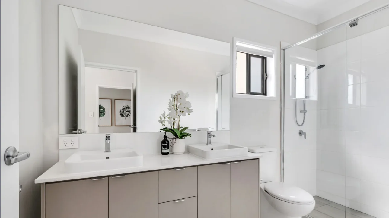 Bathroom with a frameless glass shower screen and a large vanity mirror