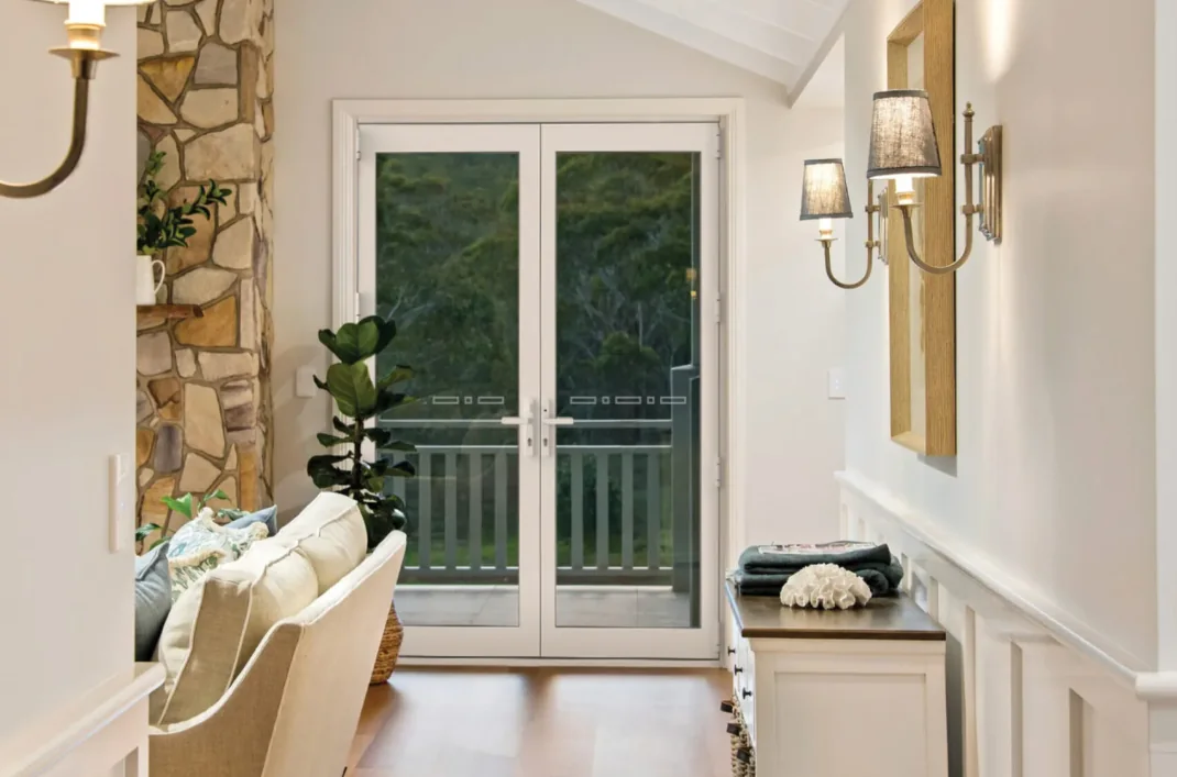 White timber-look French doors with glass panels opening onto a balcony