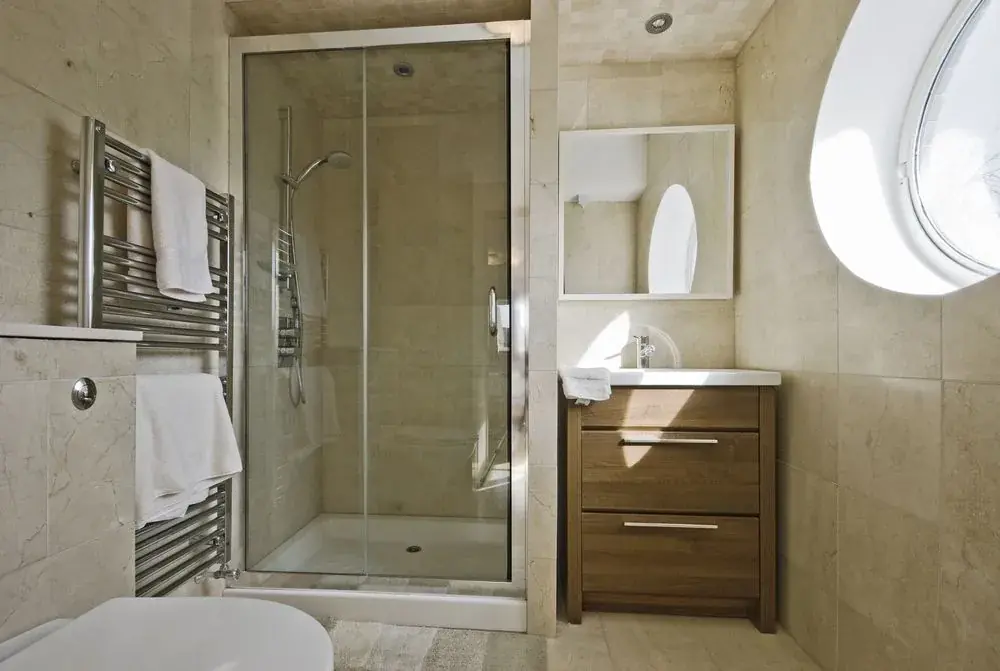 Glass shower enclosure in a tiled bathroom