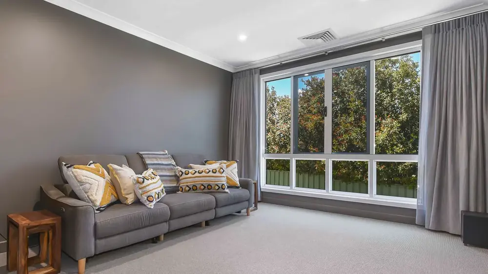 Living room with a large bank of aluminium framed windows